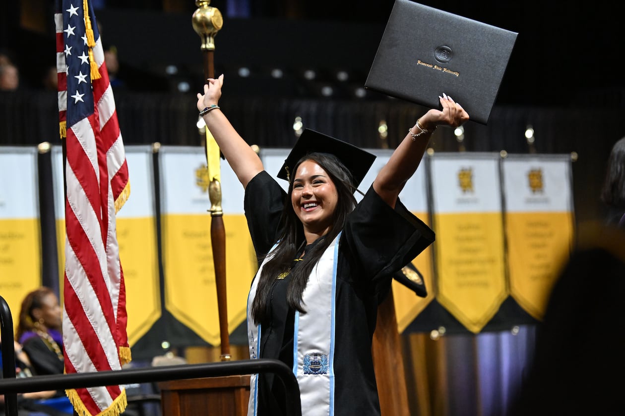 Kennesaw State University graduate Stella Roman cheers after receiving her diploma during the spring 2026 commencement at the KSU Convocation Center on Wednesday, May 13, 2026. Georgia's public universities, including KSU, could soon offer 90-hour degrees instead of the traditional 120 hours. (Hyosub Shin/AJC)