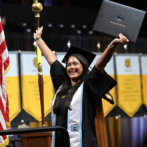 Kennesaw State University graduate Stella Roman cheers after receiving her diploma during the spring 2026 commencement at the KSU Convocation Center on Wednesday, May 13, 2026. Georgia's public universities, including KSU, could soon offer 90-hour degrees instead of the traditional 120 hours. (Hyosub Shin/AJC)