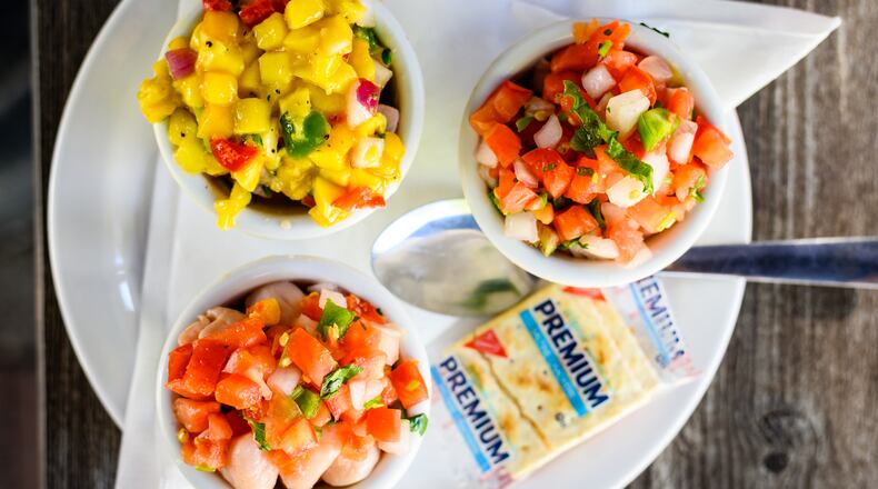 The Ceviche First Timer includes a choice of three types of marinated seafood; clockwise from top: mahi, tuna and scallop.