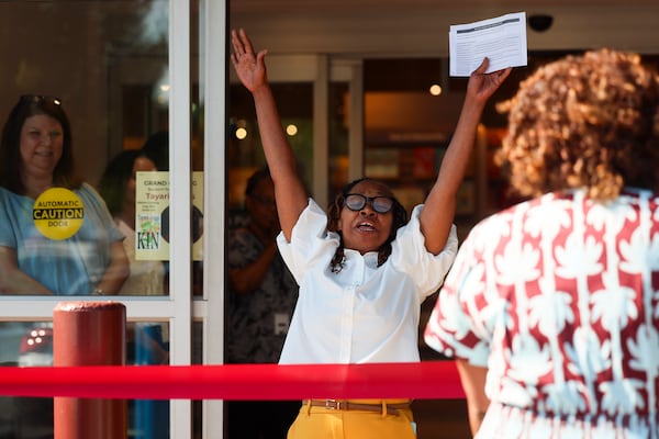 Barnes & Noble store manager LaNisha Bates, center, reacts during the ribbon-cutting ceremony welcoming customers for the grand opening of the Barnes & Noble at the Edgewood Retail District on Moreland Avenue, Wednesday, July 8, 2026, in Atlanta. The Edgewood Barnes & Noble offers 15,000 square feet of books, toys, games, magazines, and more. It is in the former Office Depot space next to Kroger. (Jason Getz/AJC)