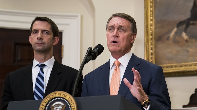Sen. David Perdue, R-Ga., (foreground) and Sen. Tom Cotton, R-Ark., deliver a statement after President Donald Trump announced proposed immigration legislation at the White House, in Washington, Aug. 2, 2017. (Doug Mills/The New York Times)