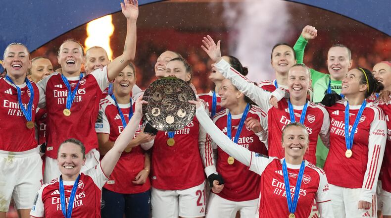 FILE - Arsenal's team captains Kin Little, left, and Leah Williamson, right, lift the trophy after winning the Women's Champions Cup final soccer match between Arsenal FC and SC Corinthians in London, Sunday, Feb. 1, 2026. (AP Photo/Alastair Grant, File)