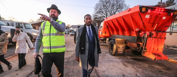 ATLDOT Commissioner Josh Rowan (left) talks to Mayor Andre Dickens about snow preparations at the ATLDOT North Avenue Facility in Atlanta on Friday, Jan. 14, 2022. (John Spink / John.Spink@ajc.com)
