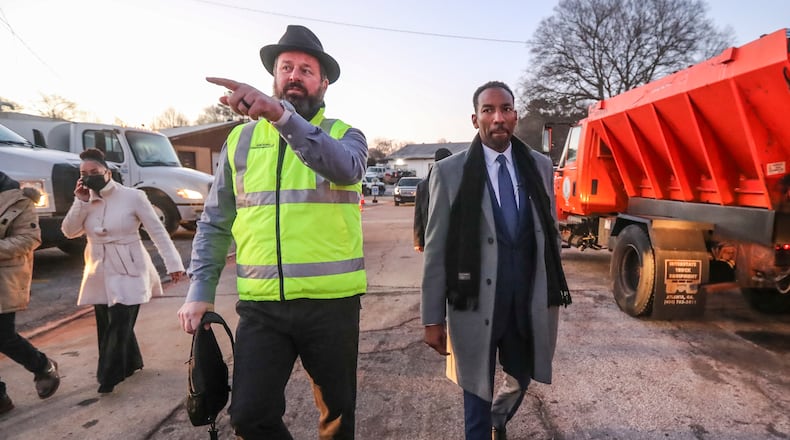 January 14, 2022 Atlanta: City of Atlanta DOT Commissioner, Josh Rowan (left) talks to Mayor, Andre Dickens (right) about snow preparations at the ATL DOT North Avenue Facility in Atlanta on Friday, Jan. 14, 2022 where preparations include, 40 pieces of snow equipment, with more available through contractor support. 300 employees, 150 per shift. 22,500 gallons of brine, 5,550 tons of salt, 200 tons of gravel and 150 tons of sand. Channel 2 Action News meteorologist, Brian Monahan said the storm will begin as rain for most of North Georgia on Saturday night, and the northeast mountains will be the first to transition to a wintry mix early Sunday morning. The mix will expand to the west throughout the morning, with snow, sleet and freezing rain continuing all day Sunday, he said. Temperatures are not expected to leave the 30s. As of Friday, meteorologists said I-20 looks to be the dividing line between wintry weather and just rain. Heavy rain is expected for neighborhoods to the south. Those north of Lake Lanier have the best chance of Òsignificant accumulating snow,Ó according to Channel 2. By the end of the day Sunday, that area could record 2 to 5 inches of snowfall and a quarter-inch of ice, according to the latest forecast. Higher elevations in the mountains could see 6 to 10 inches of snow. Snowfall is expected in Atlanta, but the jury is still out as to just how much. According to Channel 2, it has been 1,457 days since there was measurable snowfall at Hartsfield-Jackson International Airport, the second-longest no-snow streak since a 1,477-day stretch between 1948 and 1952. (John Spink / John.Spink@ajc.com)