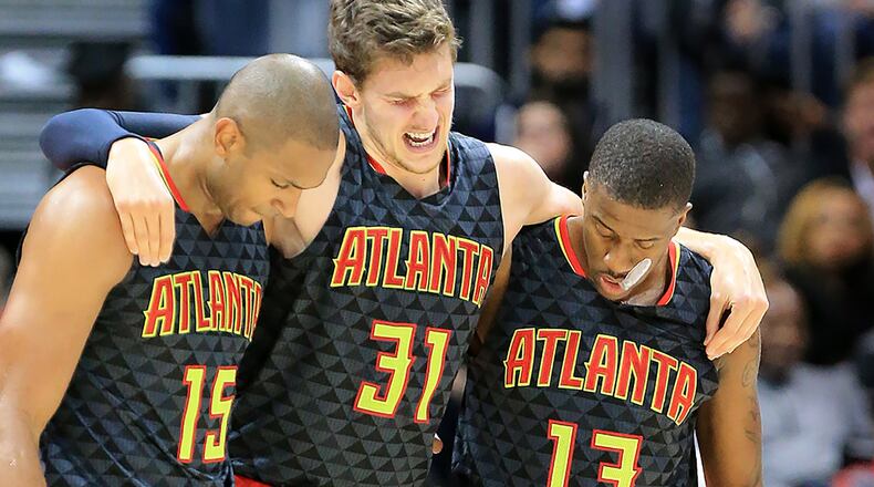 Hawks’ Al Horford (left) and Lamar Patterson (right) help Mike Muscala off the court after he was injured against the Pistrons during the second half in their first regular season basketball game on Tuesday, Oct. 27, 2015 in Atlanta. The Pistons beat the Hawks 106-94. Curtis Compton / ccompton@ajc.com
