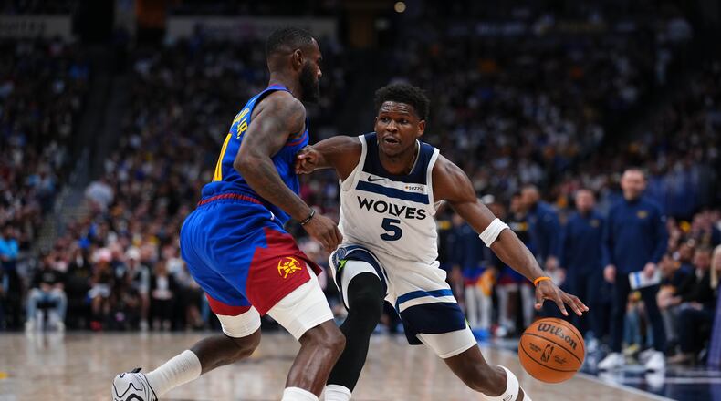 Minnesota Timberwolves guard Anthony Edwards (5) drives to the basket against Denver Nuggets guard Tim Hardaway Jr. (10) during the second half in Game 2 of a first-round NBA playoffs basketball series Monday, April 20, 2026, in Denver. (AP Photo/Jack Dempsey)