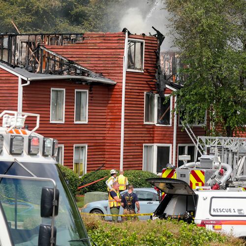 Firefighters were forced to evacuate a burning apartment building when the roof collapsed Tuesday morning in Gwinnett County. (Ben Hendren for the AJC)