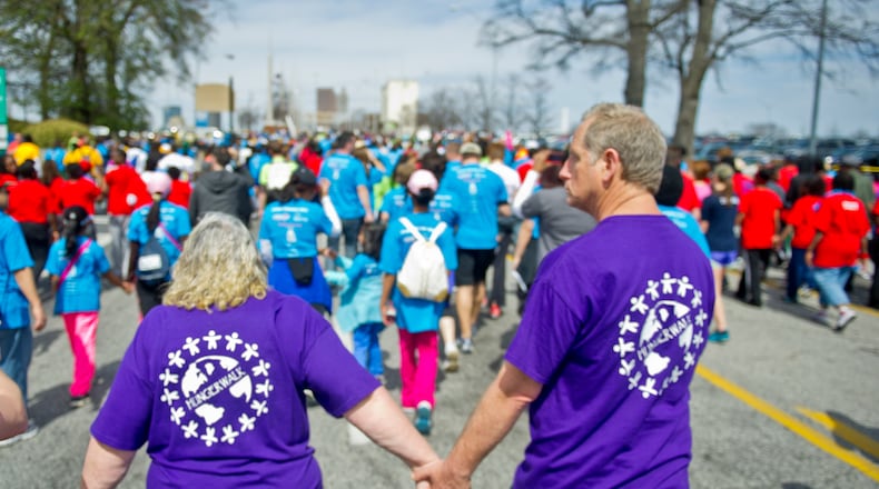 June Woodside (left) holds hands with Donald Palguta as they walk in the Hunger Walk/Run 2013.