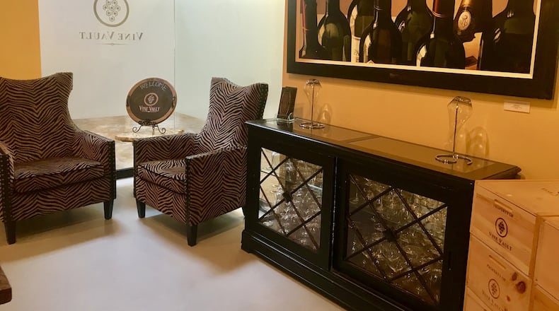 The tasting room at Vine Vault is a gathering place for members. Hanging on the walls are wine-themed paintings by local artist Thomas Arvid. LIGAYA FIGUERAS / LFIGUERAS@AJC.COM