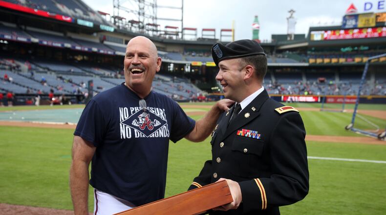 May 3, 2013 - Atlanta, Ga: U.S. Army 1st Lt. Eric Bagley, of Rockdale County, right, presents Atlanta Braves third base coach Brian Snitker with a U.S. flag after Bagley returned from a 9-month service in Afghanistan before the Braves host the New York Mets at Turner Field Friday night in Atlanta, Ga., May 3, 2013. Bagley presented Snitker with the flag for his appreciation and support after Bagley was invited to meet the team by Snitker for 2012 Spring Training. JASON GETZ / JGETZ@AJC.COM