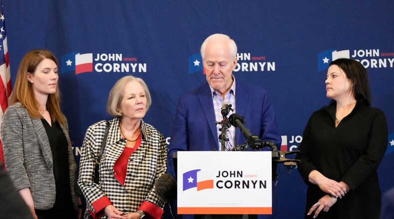 Sen. John Cornyn, R-Texas, center right, speaks alongside, from left, daughter Danley Cornyn, wife Sandy Cornyn and daughter Haley Cornyn, during a primary runoff election night event after losing the Republican party's nomination Tuesday, May 26, 2026, in Austin. (AP Photo/Ashley Landis)