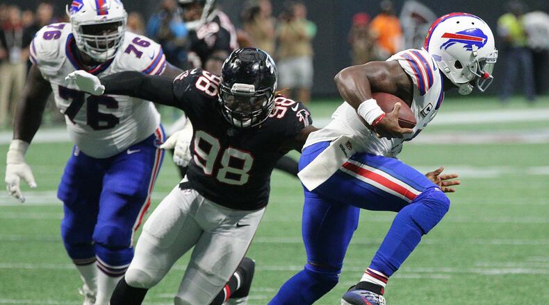 Game 4 -- Bills 23, Falcons 17: Bills quarterback Tyrod Taylor slips away from the pass rush of Falcons defensive end Takkarist McKinley for a first down run during the victory. It was the first loss of the season -- and the first regular-season loss in Mercedes-Benz Stadium -- for the Falcons. Curtis Compton/ccompton@ajc.com