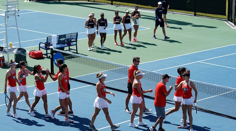 The University of Georgia women's tennis team celebrates after winning the doubles point over Virginia on the the way to a 4-1 victory in the round of 16 at the NCAA Tennis Championships (Manuela Davies/USTA)