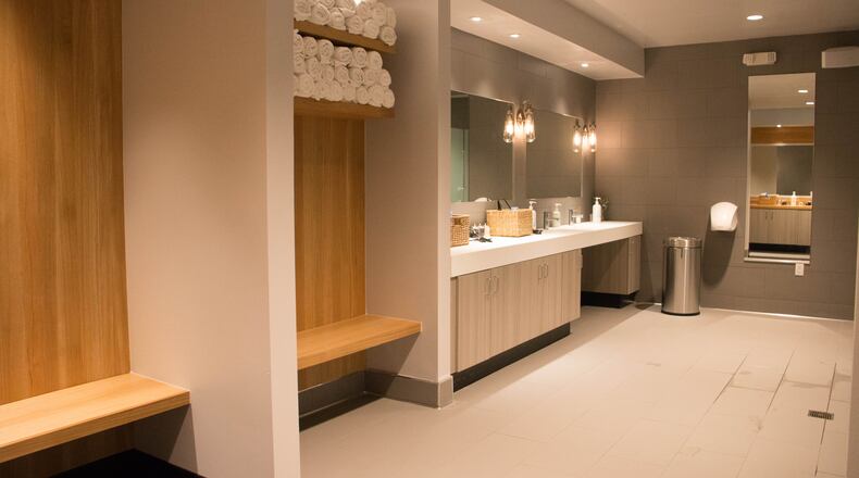Flywheel Buckhead offers multiple showers and a long mirrored countertop with hair dryers and other amenities.