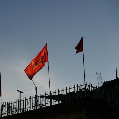 Flags of the ruling party LIBRE, Liberty and Refoundation, fly on a home's roof in Tegucigalpa, Honduras, Tuesday, Dec. 2, 2025. (AP Photo/Moises Castillo)
