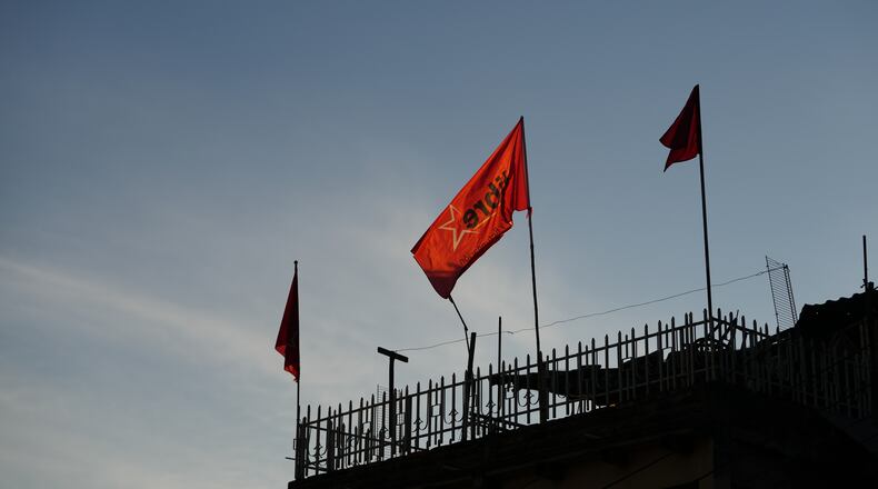 Flags of the ruling party LIBRE, Liberty and Refoundation, fly on a home's roof in Tegucigalpa, Honduras, Tuesday, Dec. 2, 2025. (AP Photo/Moises Castillo)