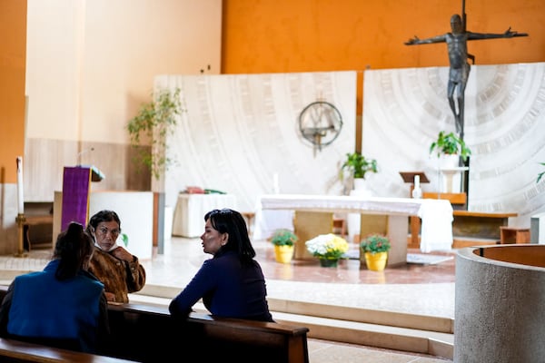 FILE - Transgender women, from left, Claudia Vittoria Salas, Andrea Paola Torres Lopez and Carla Segovia speak as they sit in the Beata Vergine Immacolata church in Torvaianica, Italy, on Nov. 16, 2023. (AP Photo/Andrew Medichini, File)