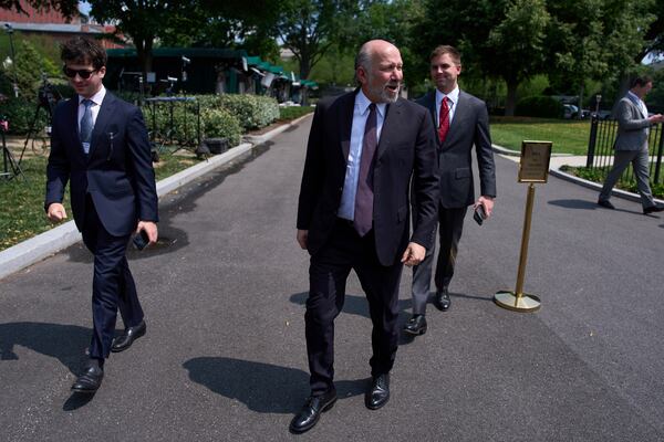 Commerce Secretary Howard Lutnick speaks with reporters as he walks by at the White House, Wednesday, June 11, 2025, in Washington. (AP Photo/Evan Vucci)