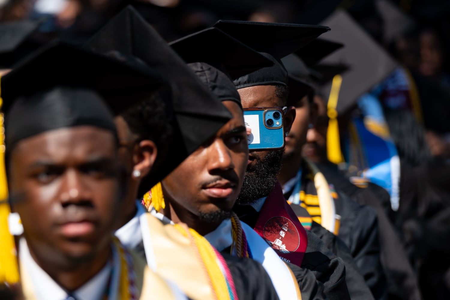 A graduate snaps a photo during the Morehouse College graduation Sunday, May 17, 2026. (Ben Gray for the AJC)