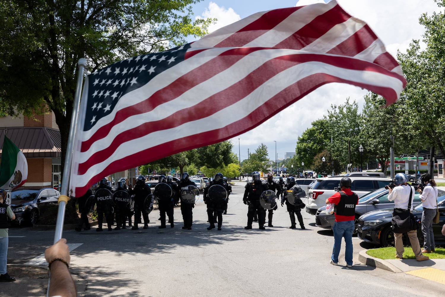 Police force protestors back during a protest on ICE raids and deportation arrests on Chamblee Tucker Road in Atlanta on Saturday, June 14, 2025. (Arvin Temkar / AJC)