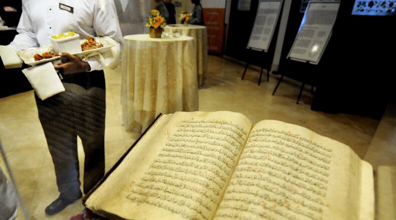 The Al-Farooq Masjid during an open house. .A 500 year-old Quran was on display in the lobby as hors d’oeuvres are served. STAFF PHOTO