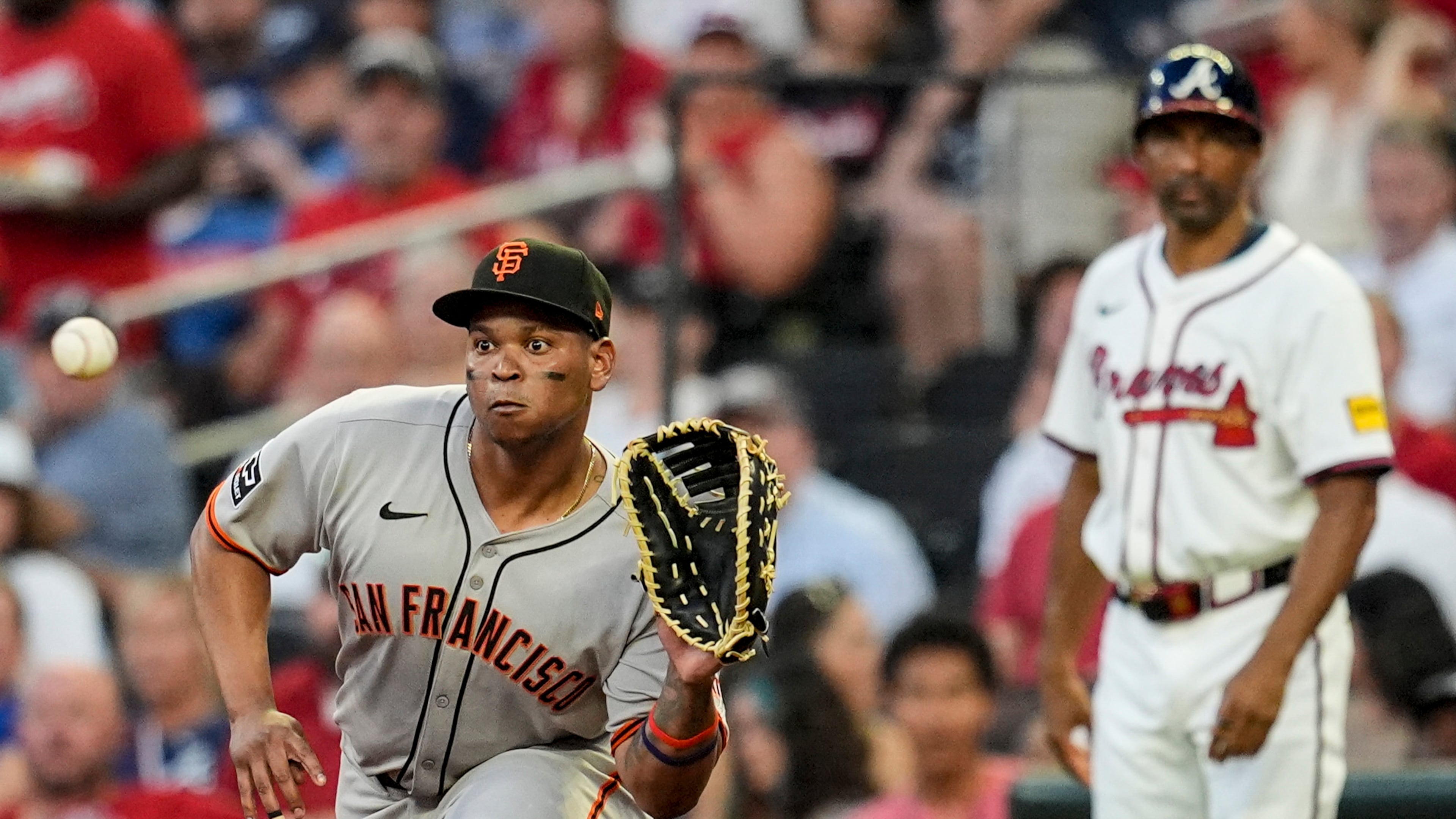 San Francisco Giants' Rafael Devers (16) makes the tag on Atlanta Braves' Nick Allen (2) at first base in the fifth inning of a baseball game, Tuesday, July 22, 2025, in Atlanta. (AP Photo/Mike Stewart)