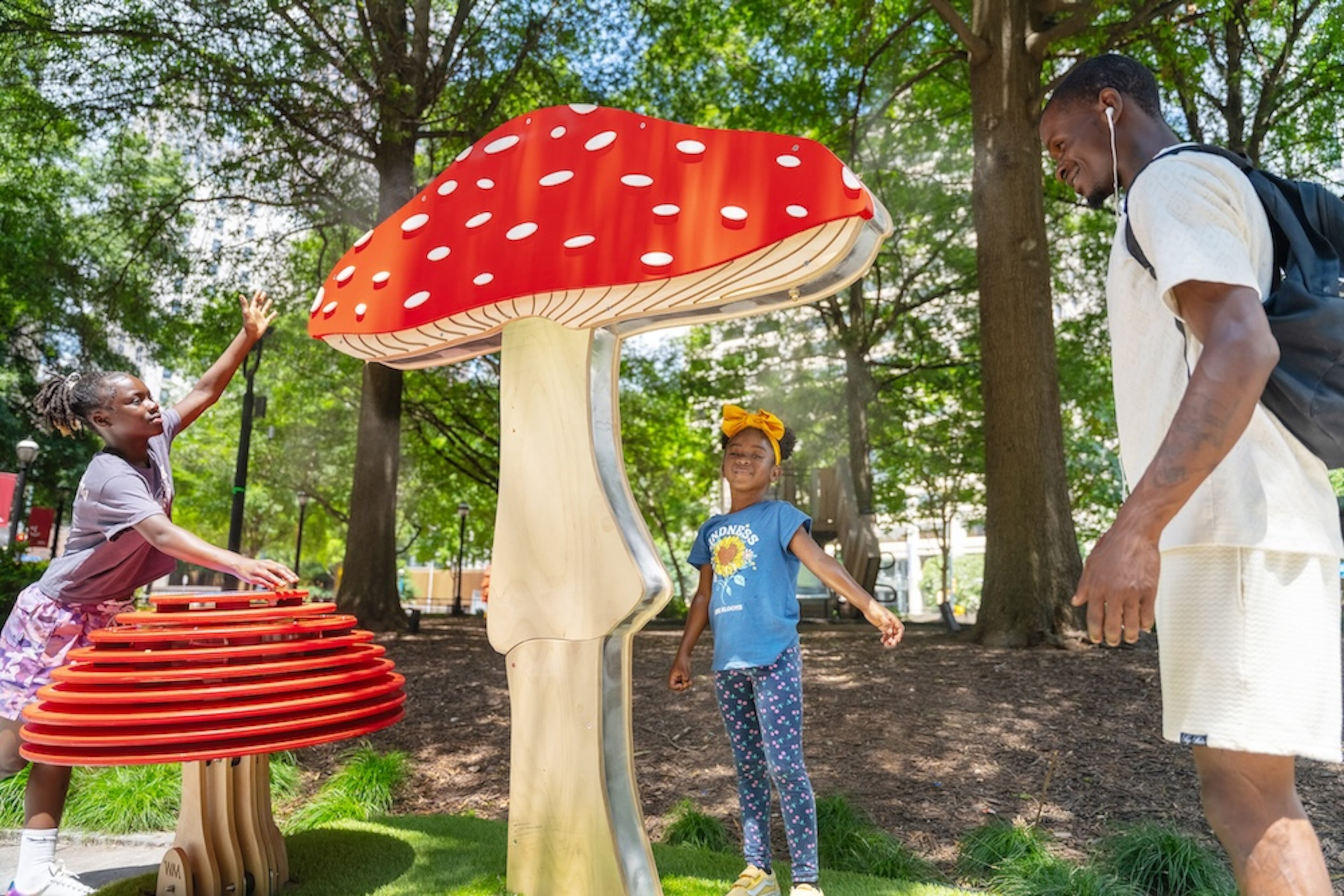 The interactive art installation "Misting Mushrooms" at Woodruff Park is cool and cooling.
