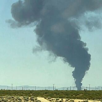 Smoke plumes rise from a B-52 bomber that crashed shortly after takeoff at a U.S. Air Force base in Southern California, Monday, June 15, 2026. (Debbie Reyes Katz via AP Photo)