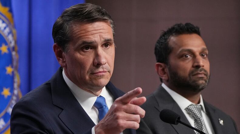 Acting Attorney General Todd Blanche speaks as FBI Director Kash Patel listens during a news conference at the Justice Department, Tuesday, April 21, 2026, in Washington. (AP Photo/Jacquelyn Martin)