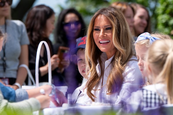 First lady Melania Trump participates in flag decorating during a Take Our Child to Work Day event in the Jacqueline Kennedy Garden at the White House, Tuesday, May 20, 2025, in Washington. (AP Photo/Alex Brandon)