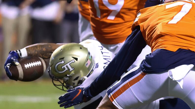 Georgia Tech running back Dontae Smith (4) reaches out for the touchdown next to Virginia outside linebacker Noah Taylor (7) Saturday, Oct. 23, 2021, in Charlottesville, Va. (Andrew Shurtleff/The Daily Progress)