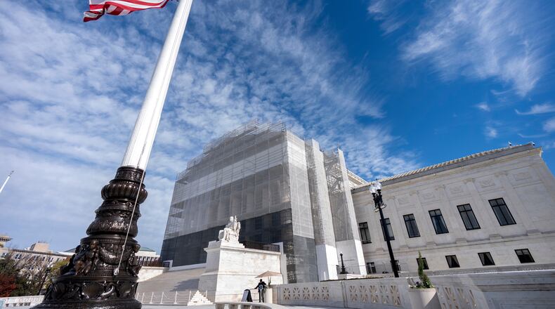 An American flag flies at half-staff outside the Supreme Court on Wednesday, Nov. 5, 2025, in Washington. (AP Photo/Mark Schiefelbein)