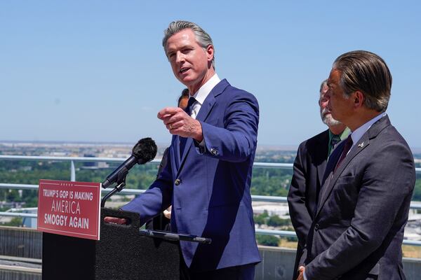 Standing atop the Cal. EPA building, Calif. Gov. Gavin Newsom discusses the U.S. Senate 's vote against California Emissions rules which include the ban on the sale of new gas powered cars by 2035. Sacramento, Calif., Thursday May 22, 2025. At right is California Attorney General Rob Bonta. (Photo/Rich Pedroncelli)
