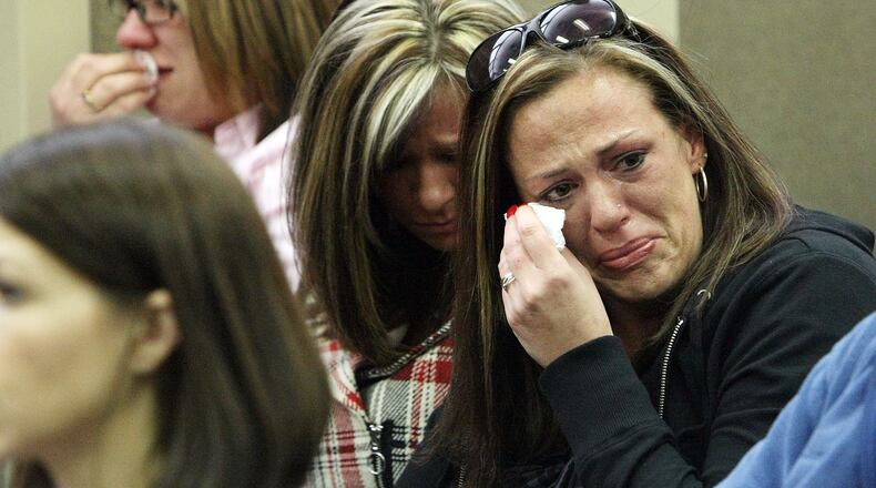Relatives of Zachariah Werner cry as suspected shooter Jesse James Warren appears in a Cobb County court Marietta on February 26, 2010.
