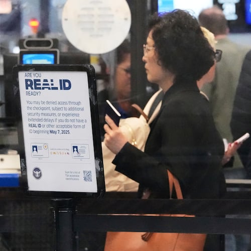 FILE - A Real ID sign is displayed as Travelers wait to go through security check point at O'Hare International Airport in Chicago, May 23, 2025. (AP Photo/Nam Y. Huh, File)