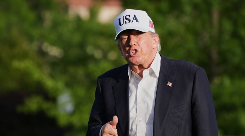 President Donald Trump gestures to reporters as he walks across the South Lawn of the White House, Friday, May 15, 2026, in Washington, on return from Beijing where he met with China's President Xi Jinping. (AP Photo/Jacquelyn Martin)