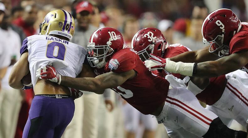 Washington tailback Myles Gaskin is knocked out of bounds by Alabama defenders in the 2016 Chick-fil-A Peach Bowl on Dec. 31 in Atlanta. The Crimson Tide won the game. Curtis Compton/ccompton@ajc.com