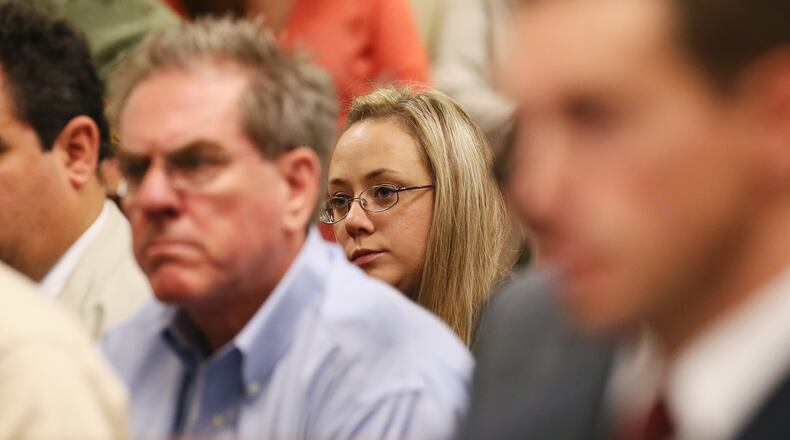 Leanna Harris, wife of Justin Ross Harris, the father of a toddler who died after police say he was left in a hot car for about seven hours, looks on during her husband's bond hearing in Cobb County Magistrate Court on July 3, 2014, in Marietta, Ga. Harris, who police say intentionally killed his toddler son by leaving the boy inside a hot SUV, was exchanging nude photos with women the day his son died and had looked at websites that advocated against having children, a detective testified Thursday. At that same hearing, a judge refused to grant bond for Harris, meaning he will remain in jail.