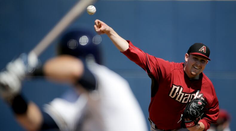 Arizona Diamondbacks starting pitcher Trevor Cahill, right, throws to Milwaukee Brewers' Scooter Gennett during the second inning of a spring training baseball exhibition game in Phoenix, on Friday, March 20, 2015. (AP Photo/Chris Carlson) Trevor Cahill gives Braves a right-handed starter but he struggled with Arizona. (AP photo)