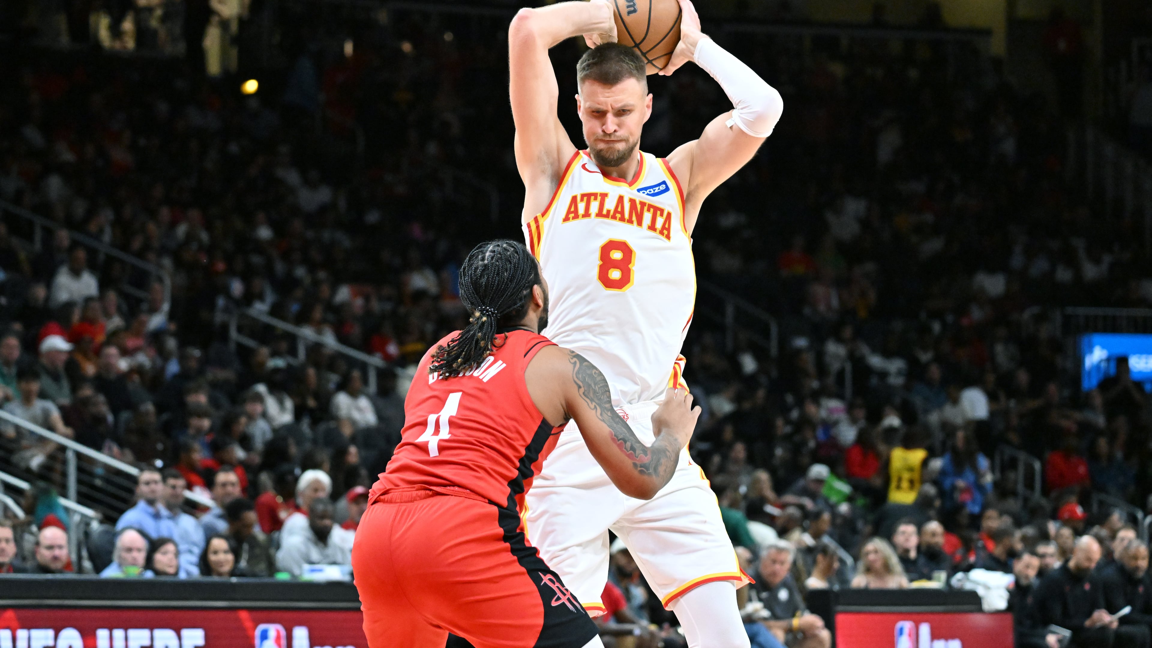 Atlanta Hawks forward/center Kristaps Porziņģis prepares to shoot against Houston Rockets JD Davison during a preseason game Thursday, Oct. 16, 2025, in Atlanta. (Hyosub Shin/AJC)