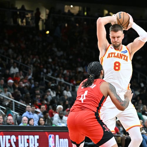 Atlanta Hawks forward/center Kristaps Porziņģis prepares to shoot against Houston Rockets JD Davison during a preseason game Thursday, Oct. 16, 2025, in Atlanta. (Hyosub Shin/AJC)
