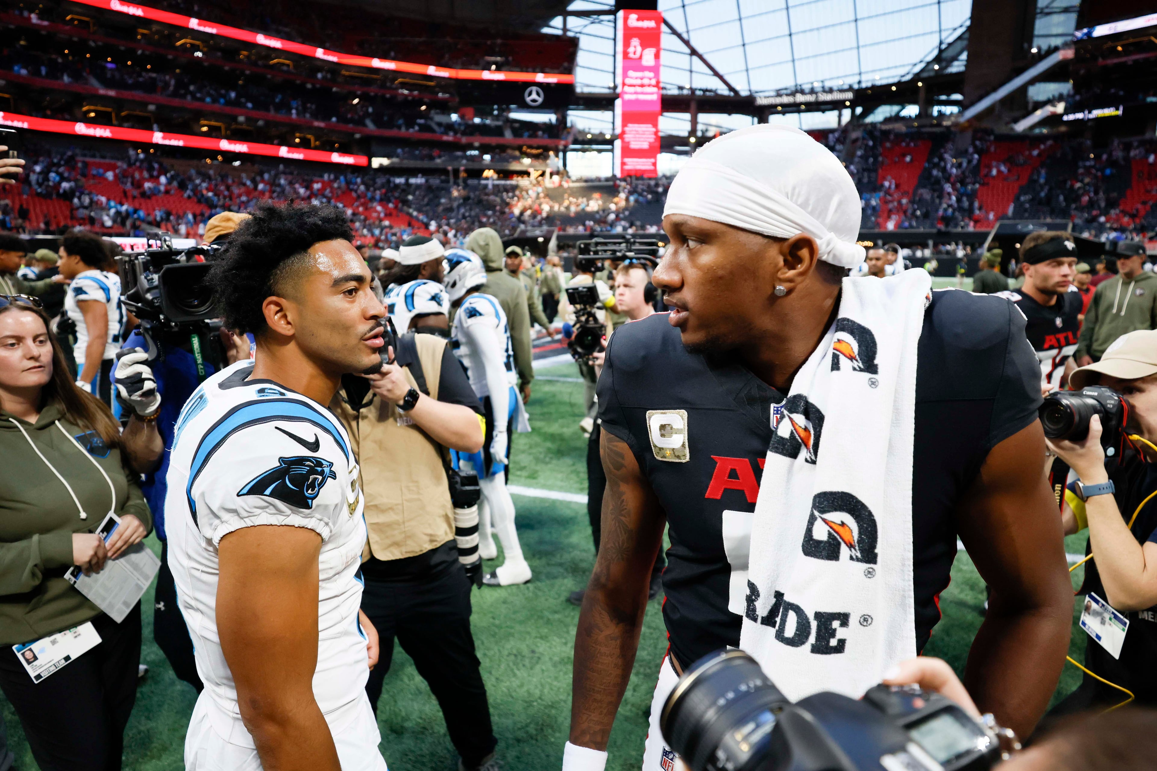 Atlanta Falcons quarterback Michael Penix Jr. interacts with Carolina Panthers quarterback Bryce Young after the game. The Carolina Panthers defeated the Atlanta Falcons in overtime, 30-27, at Mercedes-Benz Stadium in Atlanta on Sunday, Nov. 16, 2025. (Miguel Martinez/AJC)