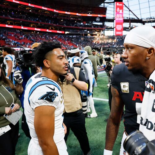 Atlanta Falcons quarterback Michael Penix Jr. (right) interacts with Carolina Panthers quarterback Bryce Young (left) at the end of the game. The Carolina Panthers defeated the Atlanta Falcons in overtime, 30-27, at Mercedes-Benz Stadium in Atlanta on Sunday, Nov. 16, 2025. (Miguel Martinez/AJC)