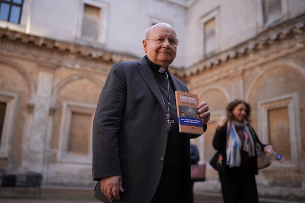 Archbishop Domenico Sorrentino poses holding his book on Carlo Acutis, the 15-year-old Italian boy who died in 2006 of leukemia and beatified in 2020, before a press conference in Rome, Thursday, April 3, 2025. (AP Photo/Alessandra Tarantino)