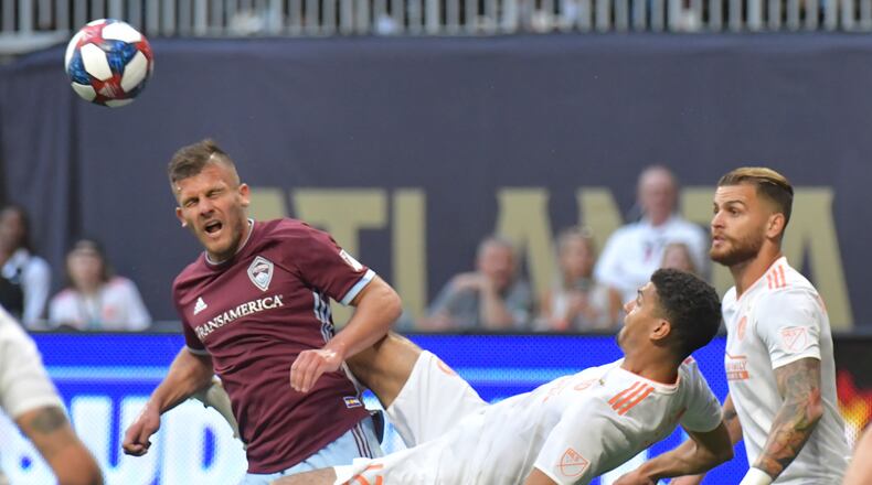 April 27, 2019 Atlanta - Atlanta United defender Miles Robinson (12) attempts a scissor kick against Colorado Rapids forward Diego Rubio (7) during the first half in a MLS soccer match at Mercedes-Benz Stadium in Atlanta on Saturday, April 27, 2019. HYOSUB SHIN / HSHIN@AJC.COM