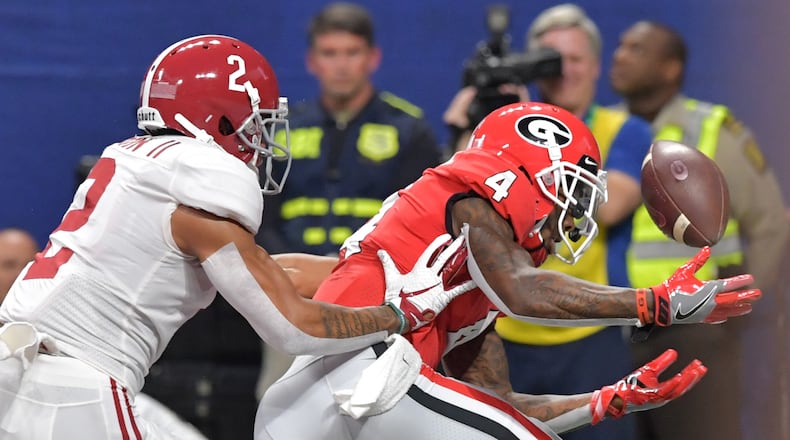 December 1, 2018 Atlanta - Georgia wide receiver Mecole Hardman (4) can not make in as Alabama defensive back Patrick Surtain II (2) tries to stop during the first half of the SEC Football Championship at Mercedes-Benz Stadium on Saturday, December 1, 2018. HYOSUB SHIN / HSHIN@AJC.COM