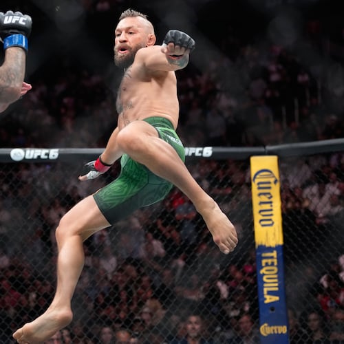Conor McGregor, right, jumps into the air for a kick as he fights Max Holloway in a welterweight fight at the UFC 329 mixed martial arts event Saturday, July 11, 2026, in Las Vegas. (AP Photo/John Locher)