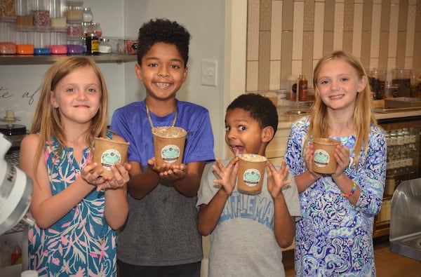 Proud new chefs (from left) Harper Wright, 9, Gionne Robinson, 10, Jacadi Robinson, 8, and Alden Wright, 9 show off their just-made Edible Sugar Cookie Dough. Gionne and Jacadi are White’s sons. CONTRIBUTED BY CHRIS HUNT PHOTOGRAPHY