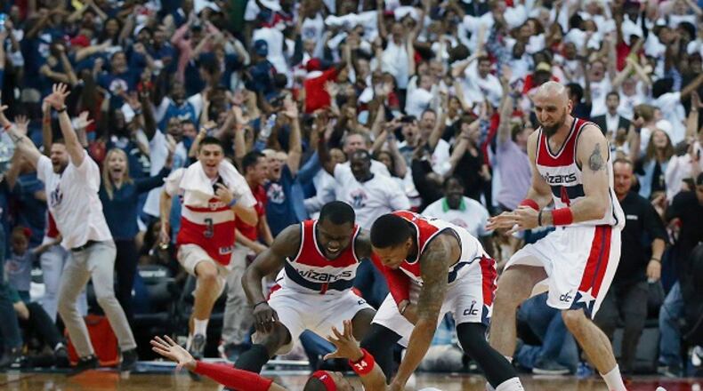 Washington Wizards players mob Paul Pierce on the floor after his game winning shot as time expired after Game 3 of the second round of the NBA basketball playoffs Saturday, May 9, 2015, in Washington. The Wizards won 103-101. Curtis Compton/ccompton@ajc.com