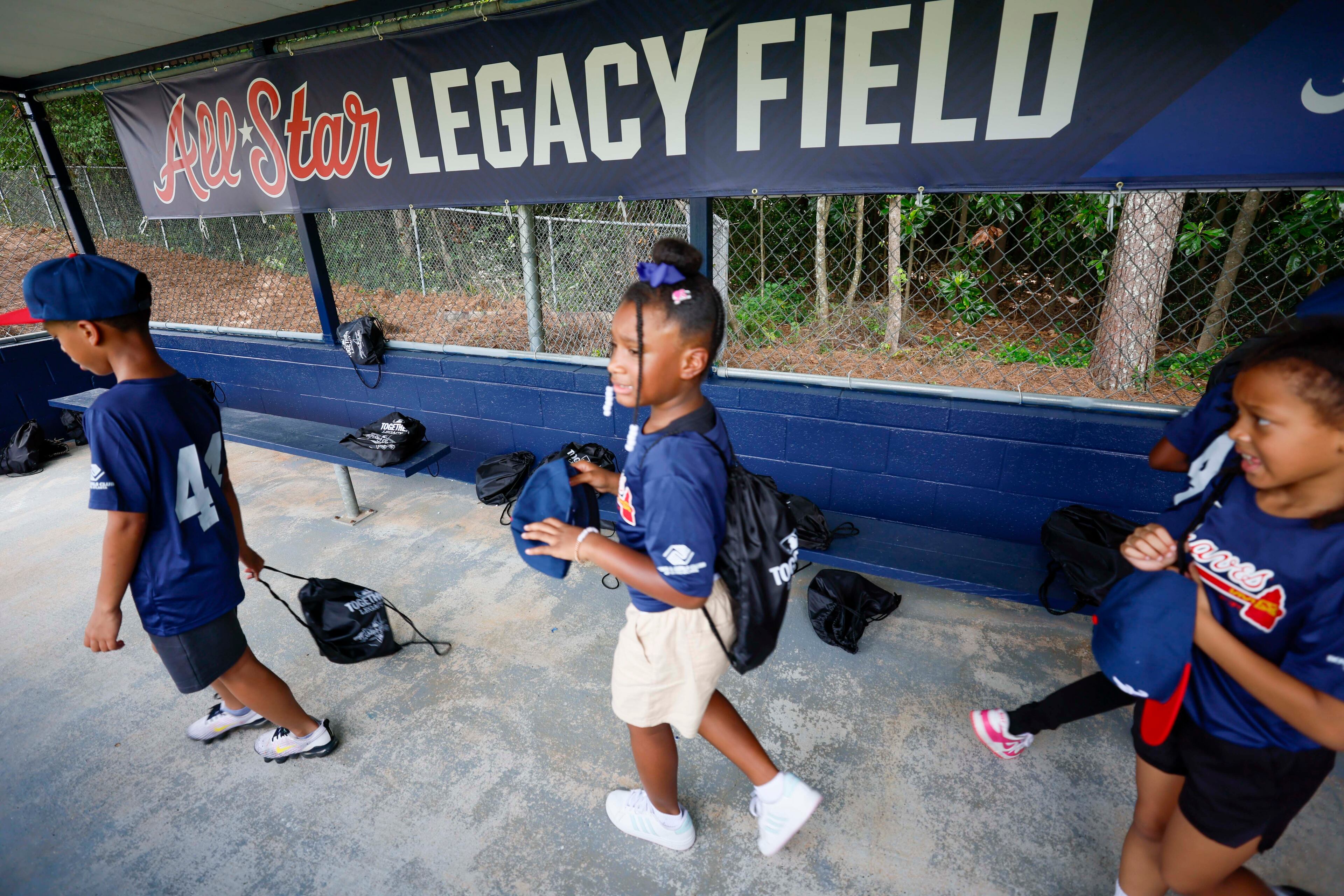 Kids are seen using the refurbished dugout during the unveiling of the new All-Star Legacy Field at the Barksdale Boys & Girls Club in Conyers on Thursday, July 10, 2025. The event takes place during the MLB All-Star Game week in Atlanta.
(Miguel Martinez/ AJC)
